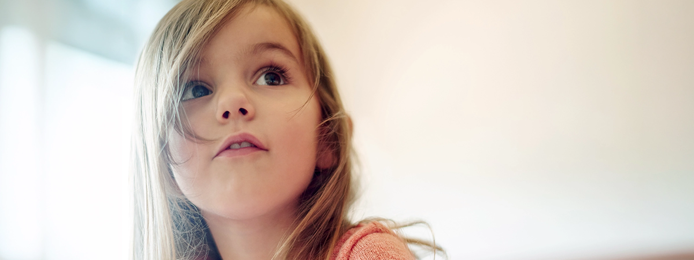 Curious child looking up with a thoughtful expression